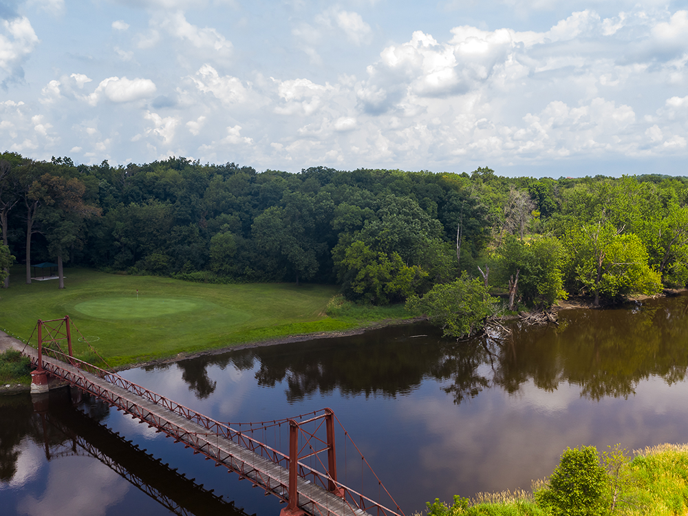 Golf course with bridge over pond